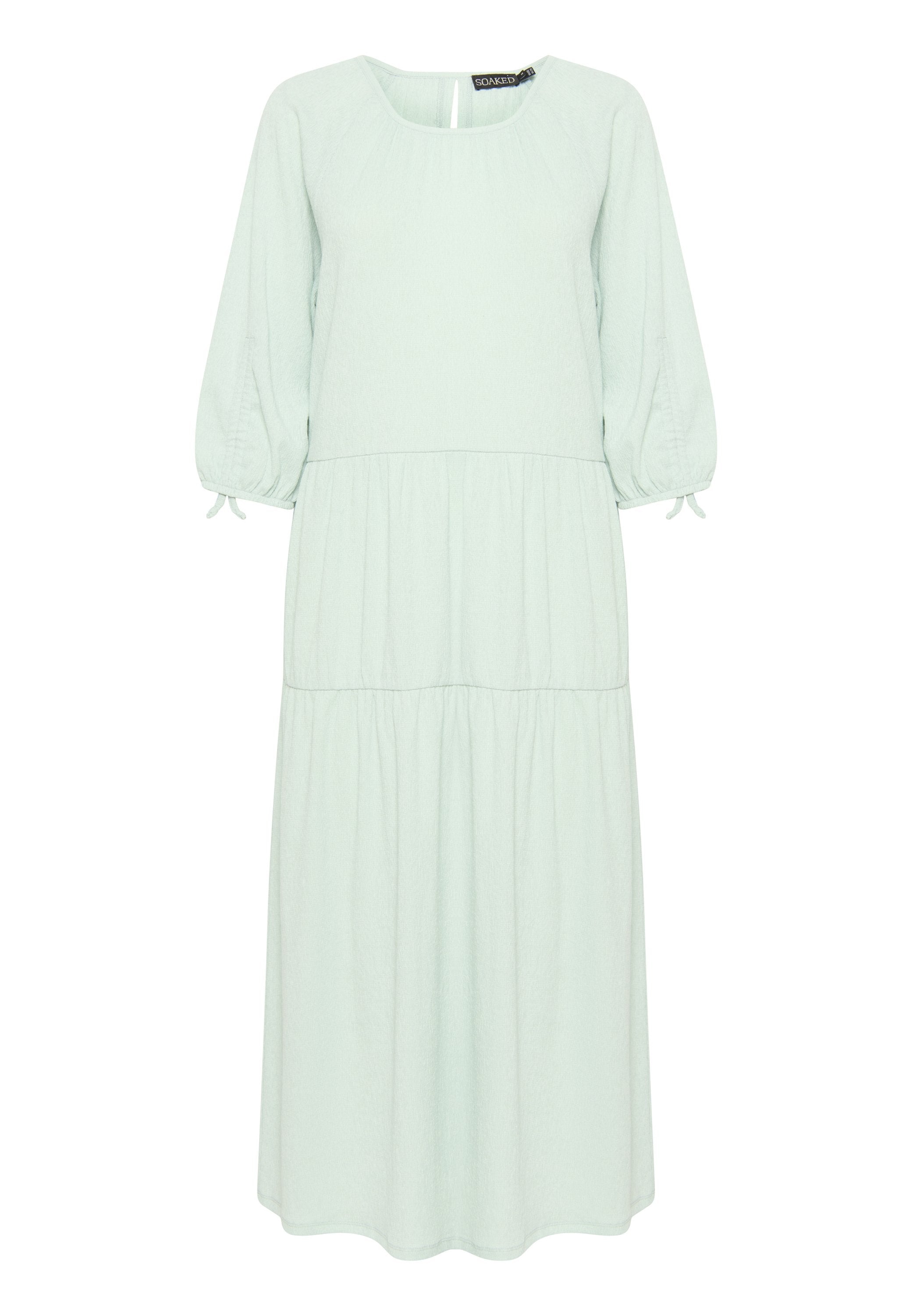Mintgrünes Midi-Kleid mit quadratischem Ausschnitt, Puffärmeln und gerafften Stufen. Hergestellt aus weichem Stoff mit verstellbaren Ärmelschnüren.