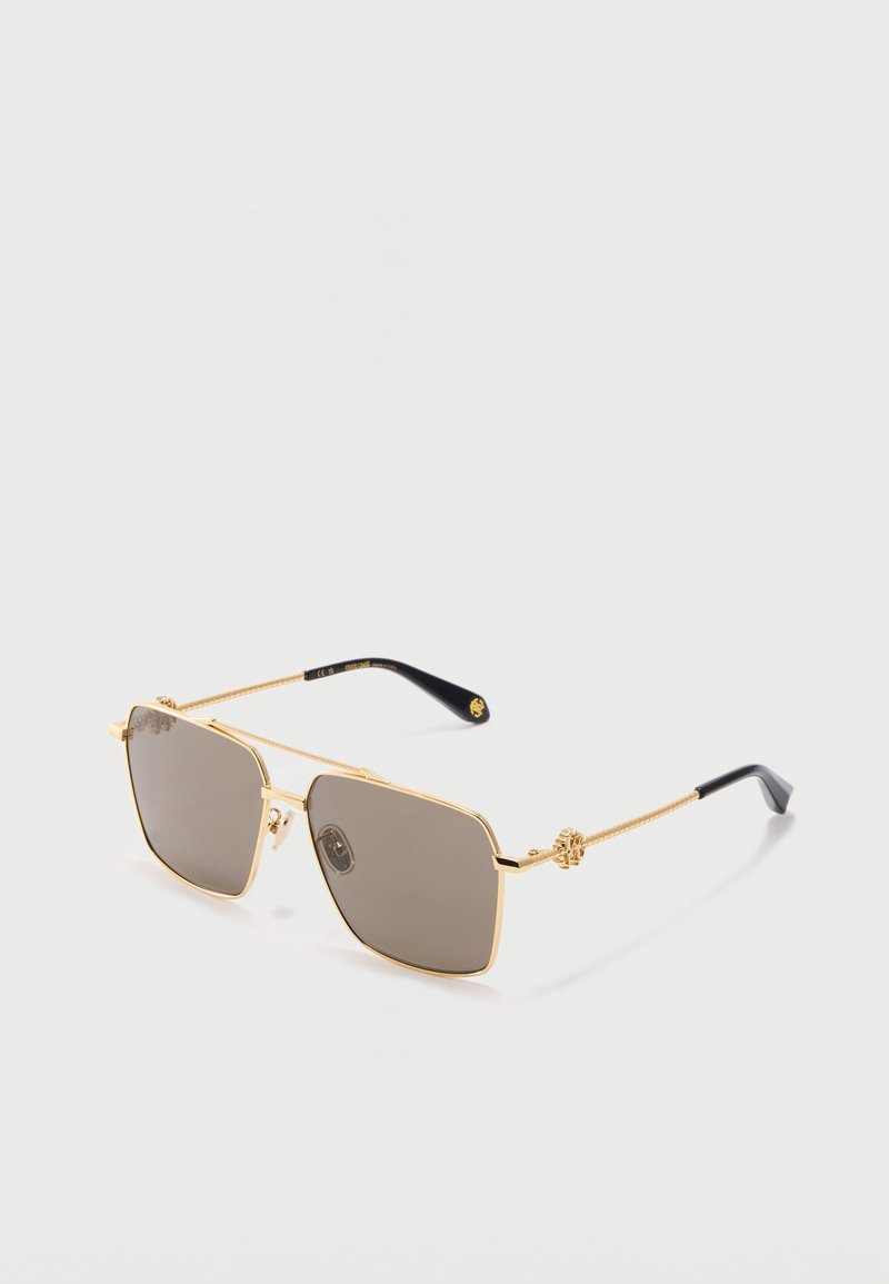 Quadratische Sonnenbrille mit goldfarbenen Metallgestellen, braun getönten Gläsern und schwarzen Bügelenden vor weißem Hintergrund.