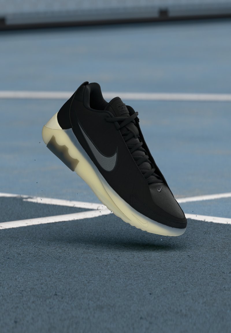 Nike Sneakers aus schwarzem Mesh mit einem grauen Swoosh, ausgestattet mit einer halbtransparenten gelben Sohle, die für den sportlichen Einsatz konzipiert sind.