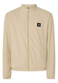 Beige Zip-Jacke mit hohem Kragen, strukturiertem Stoff, elastischen Bündchen und einem schwarzen Logo-Patch auf der linken Brust.