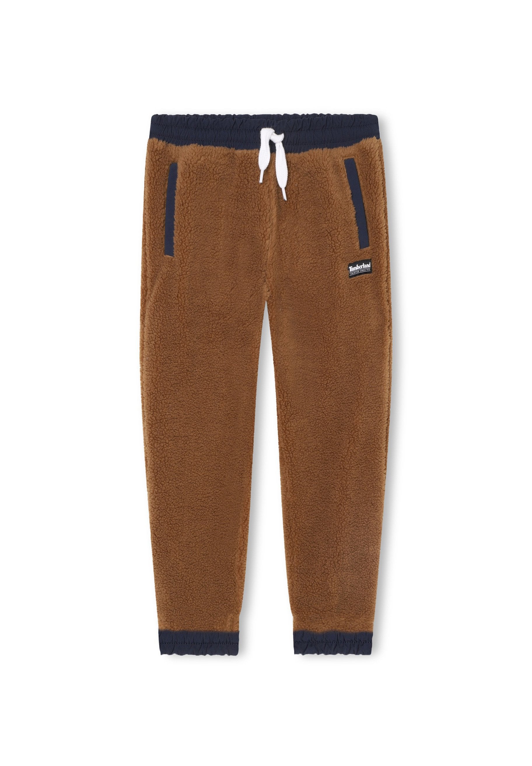 Braune Fleece-Jogginghosen mit weichem Material, marineblauem Bund und Fußbündchen, weißen Kordeln und zwei Seitentaschen. Markenlogo nahe dem Bund.