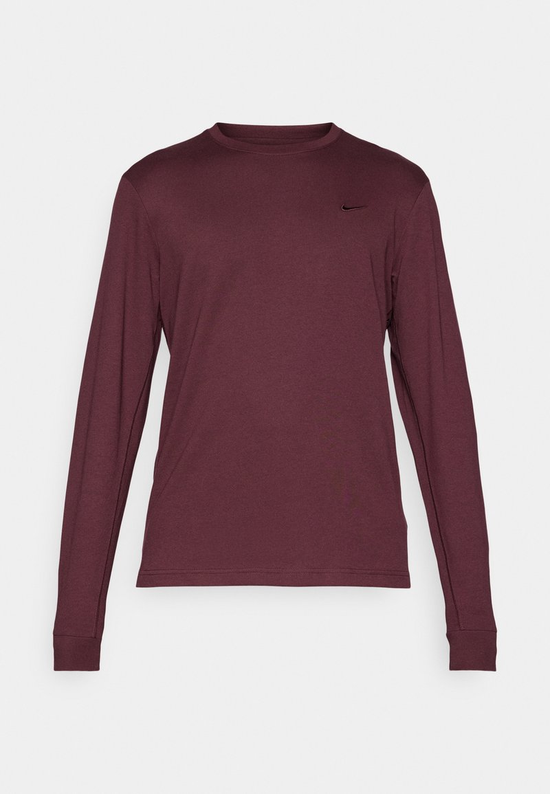 Langärmliges, kastanienbraunes Crewneck-Shirt mit einem kleinen schwarzen Nike-Logo auf der linken Brust, dargestellt vor einem weißen Hintergrund.