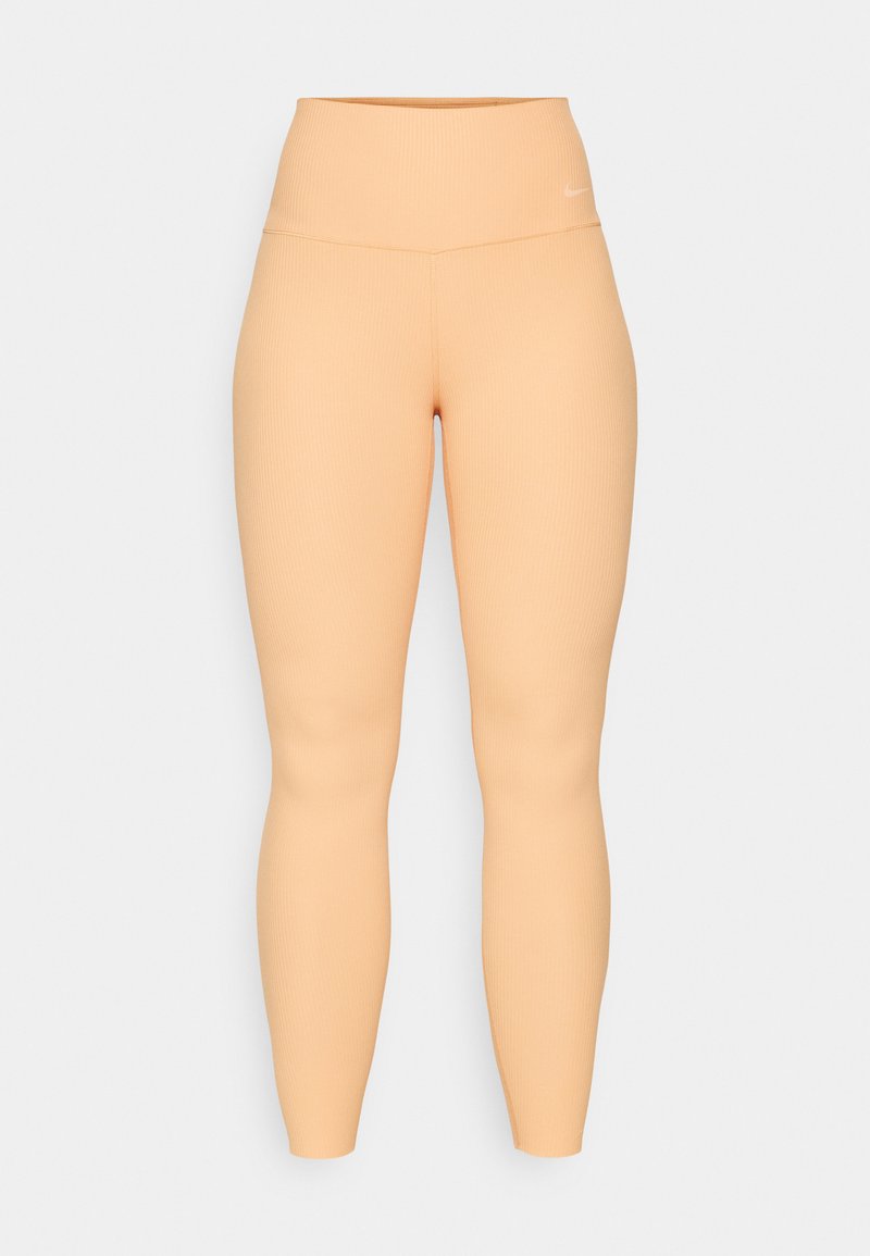 Hochtaillierte, gerippte Leggings in Pfirsichfarbe. Sie zeichnen sich durch ein elastisches, figurbetontes Design ohne sichtbare Beschläge oder Muster aus.
