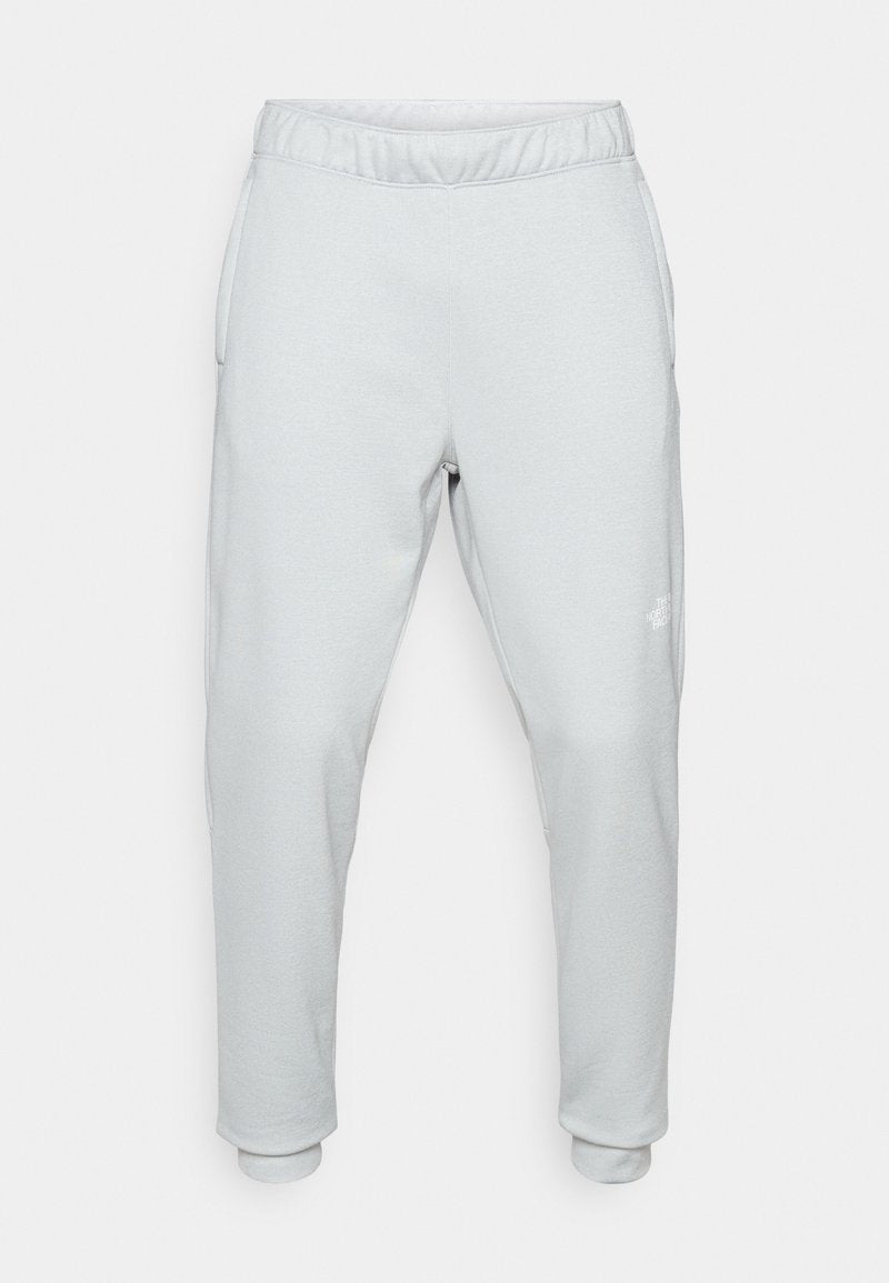 Helle graue Jogginghose aus weichem Material, mit einem elastischen Bund, seitlichen Taschen und schmal zulaufenden Bündchen. Minimalistisches Design mit Logodetail.
