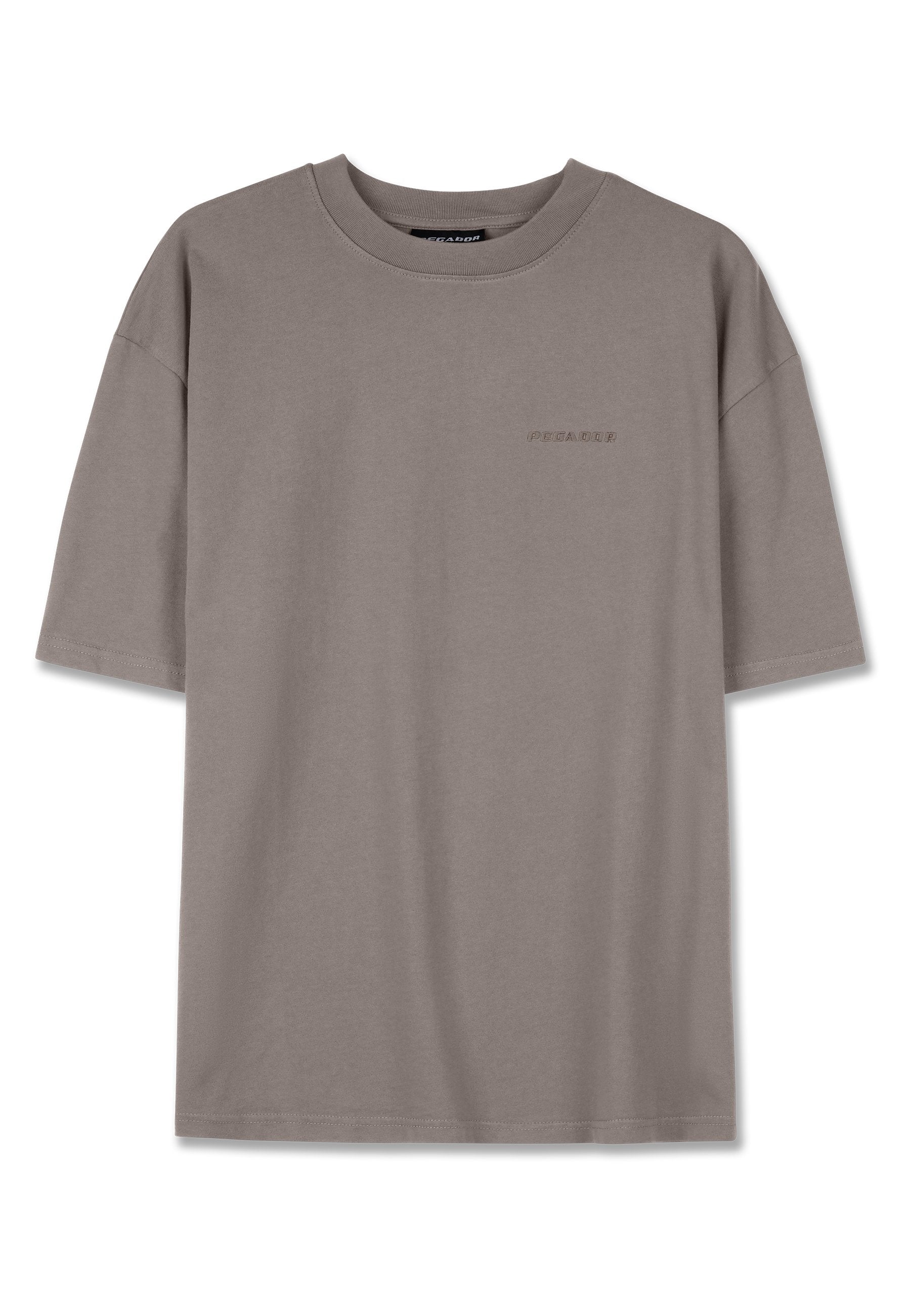 Graues T-Shirt mit kurzen Ärmeln aus weichem Baumwollstoff. Mit rundem Halsausschnitt und dezentem, gesticktem Logo auf der Vorderseite. Lockerer Schnitt.