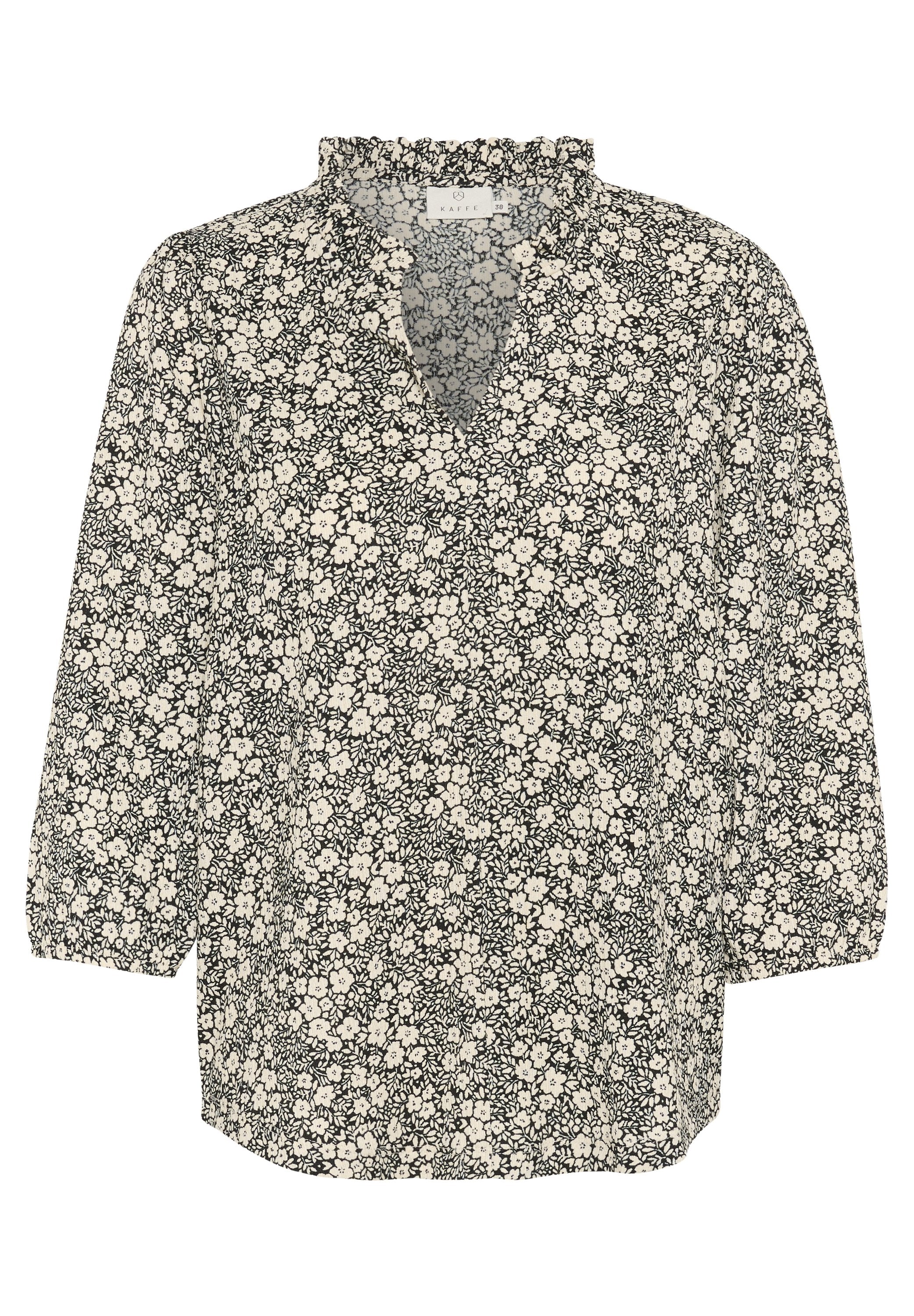 Schwarze und weiße Bluse mit floralen Mustern, tiefem V-Ausschnitt, Rüschenkragen und Dreiviertelärmeln. Hat ein kleines, durchgängiges Blumenmuster.