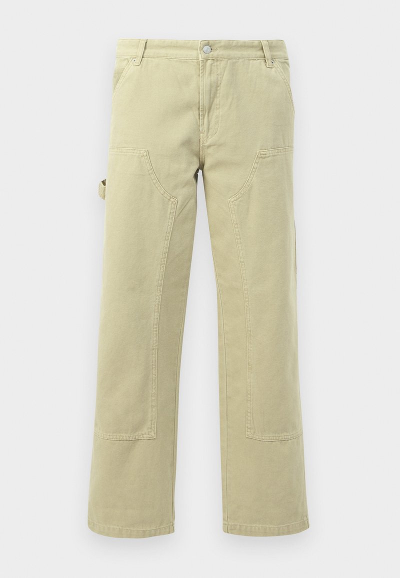 Beige Baumwoll-Hosen mit weitem Bein, ausgestattet mit vorderen und seitlichen Taschen, mit einer Panelnaht und einem Gürtelschlaufen am Bund.