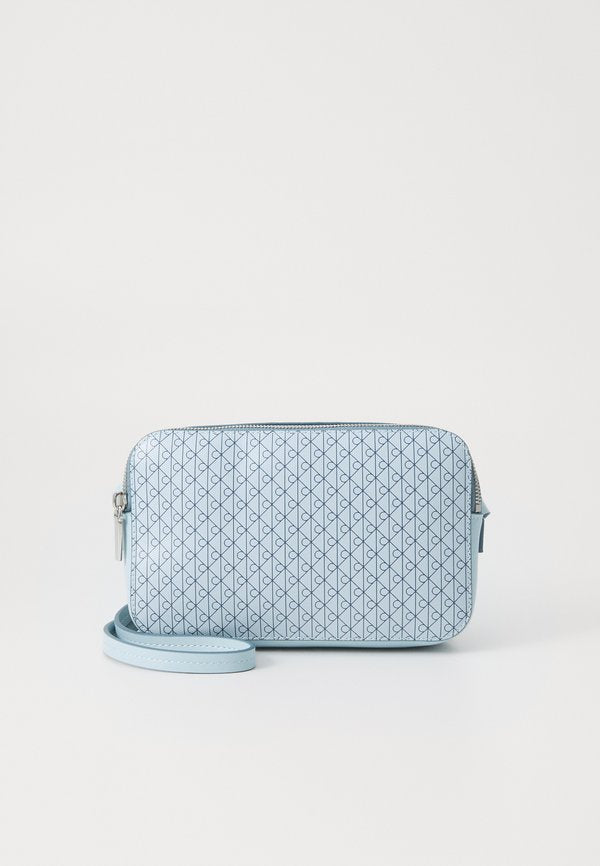 Calvin Klein EMBLEM AOP ELONGATED CAMERA BAG - Cross body bag - palest blue