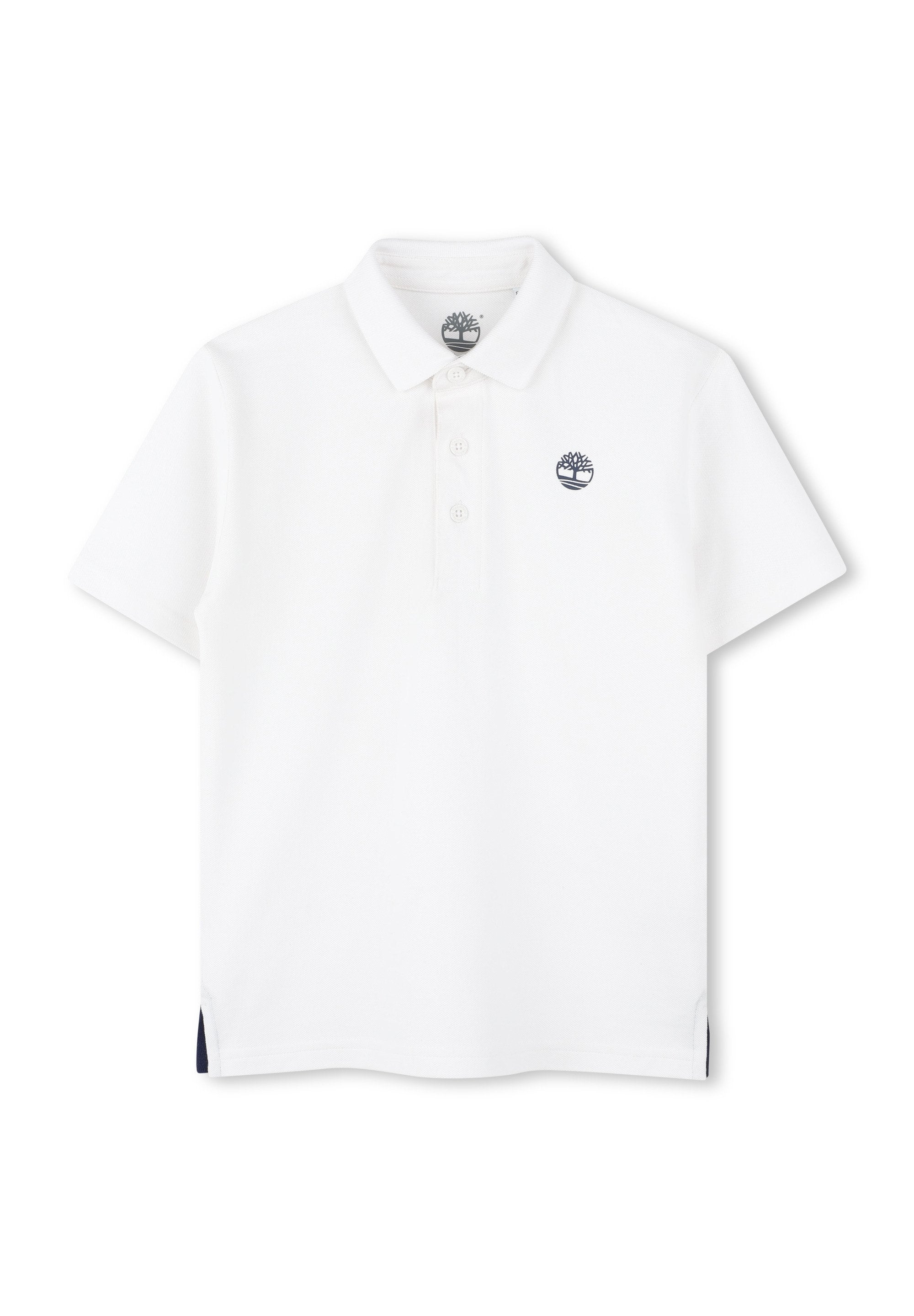 Weißes Poloshirt mit kurzen Ärmeln, dreiknöpfiger Knopfleiste und einem marineblauen Logo auf der Brust. Verfügt über seitliche Schlitzöffnungen mit marineblauen Akzenten.