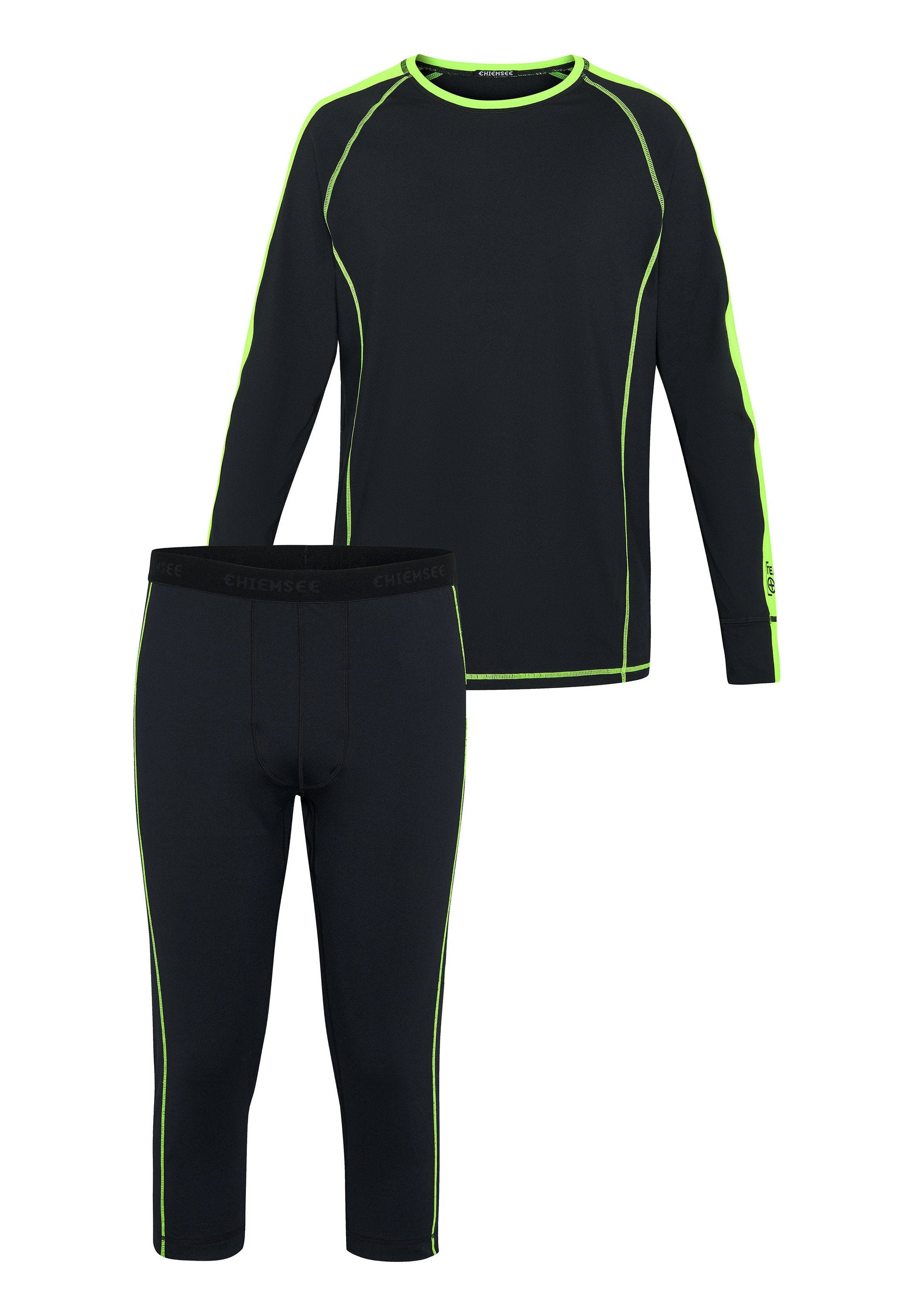 Schwarzes langärmliges Oberteil und dreiviertellange Leggings mit neongrünen Akzentnähten. Der Stoff wirkt glatt und dehnbar. Das Markenlogo ist auf dem Bund sichtbar.