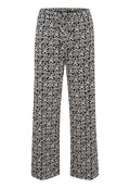 Schwarz-weiße gemusterte Hose mit entspanntem Schnitt, ausgestattet mit einem Kordelzugbund und weit fließenden Beinen, die mit kunstvollen Designs verziert sind.