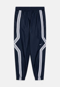 Marinefarbene Windbreaker-Hose mit weißen Streifen an den Seiten, elastischem Bund, elastischen Bündchen und einem kleinen Nike-Logo am unteren linken Bein.