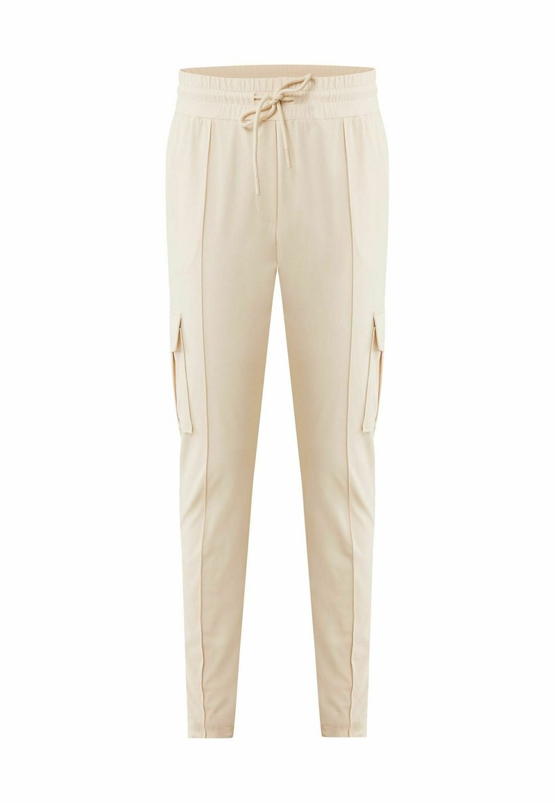 Beige Jogger-Hosen mit schmalem Schnitt, elastischem Bund und Kordelzug. Mit Seitentaschen und einem glatten, leichten Stoff.