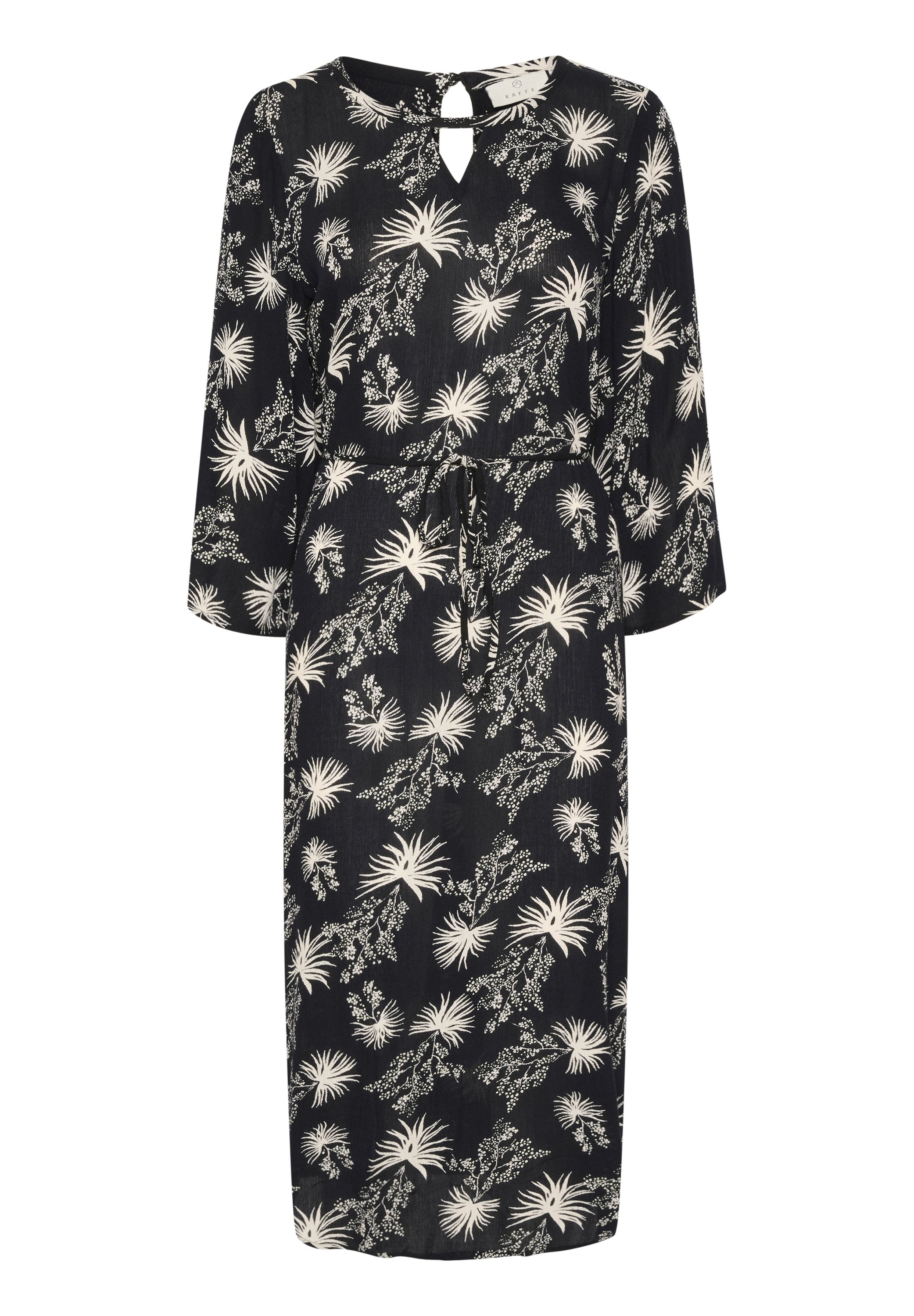Schwarzes, knielanges Kleid mit einem weißen Blumenmuster. Verfügt über lange Ärmel, einen verstellbaren Taillenzug und ein Schlüssellochdetail im Rücken.