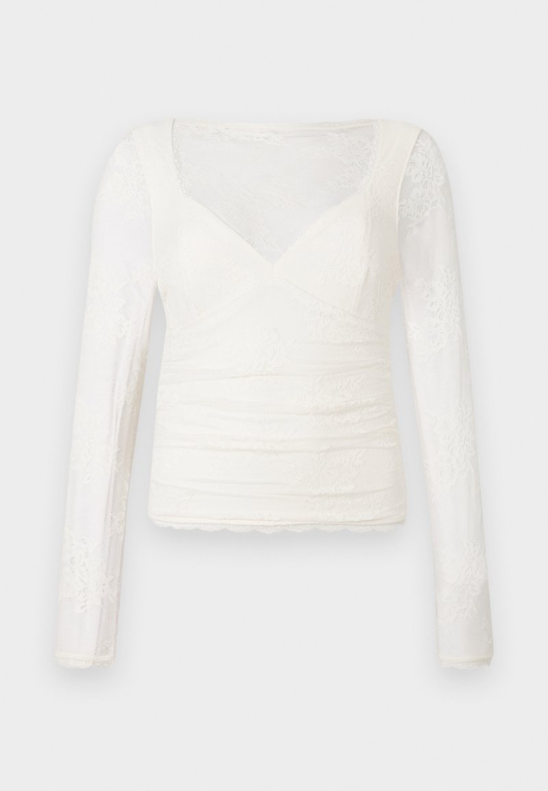 Langärmlige weiße Bluse aus strukturiertem Spitzenmaterial mit V-Ausschnitt, Raffung und gewelltem Saum.