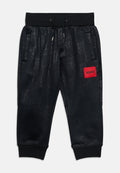 Schwarze Sweatpants mit Kordelzug, Seitentaschen, gerippten Bündchen, dezentem Strukturmuster und einem roten Patch mit der Aufschrift „HUGO“ am rechten Oberschenkel.