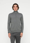 Grau melierter Pullover mit Reißverschluss bis zur Brust, langen Ärmeln, strukturiertem Strickstoff und weißem Reißverschlussdetail am Kragen. Kombiniert mit passenden grauen Hosen.
