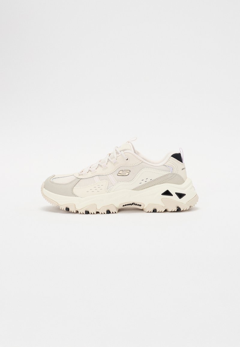 Sneaker mit einem hellbeigen und grauen Netzoberteil, strukturierten Überzügen, einer klobigen weißen Sohle und schwarzen Details an der Ferse.