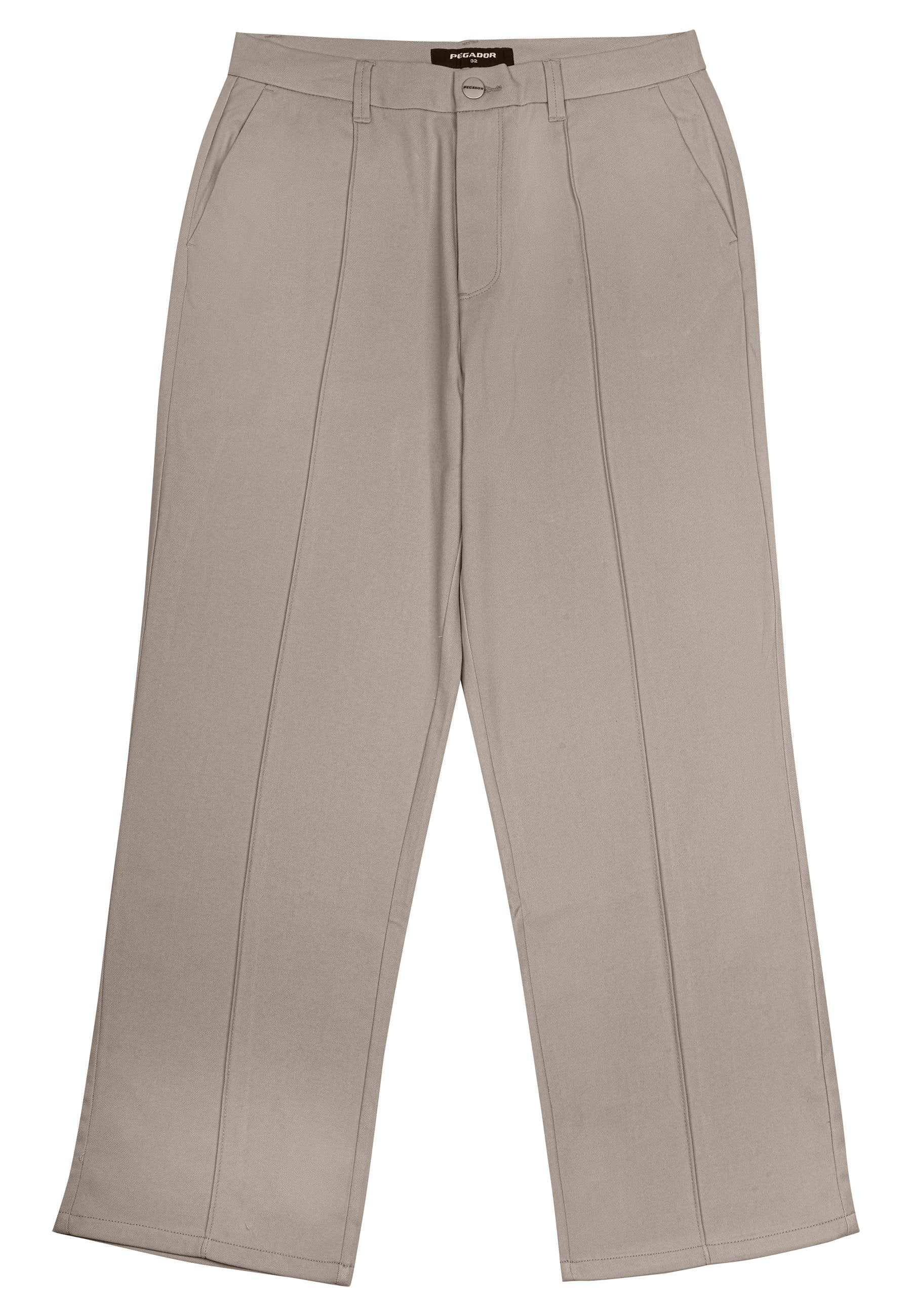 Beige weite Hosen aus Stoff, mit frontalen Taschen, einem Reißverschluss und zwei vertikalen Nähten auf jedem Bein.