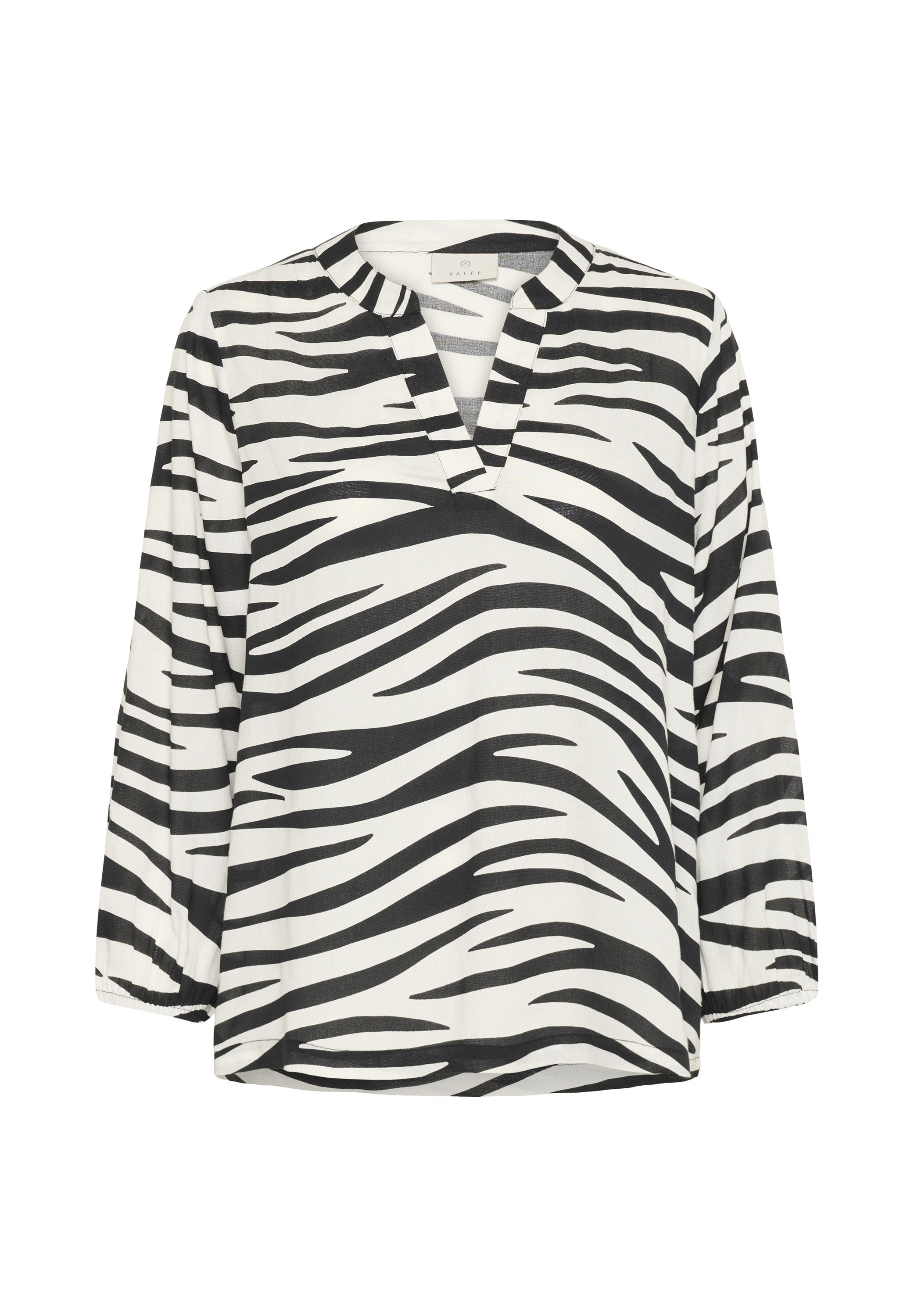 Schwarz-weiße Bluse mit Zebramuster, V-Ausschnitt, langen Ärmeln und lockerer Passform. Glattes Material mit auffälligem Streifenmuster und umschlagbarem Kragen.