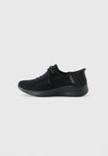Schwarzer Strick-Sneaker von Skechers mit Schnürung, strukturiertem Fersenbereich und dicker Sohle, seitlich auf einem weißen Hintergrund dargestellt.