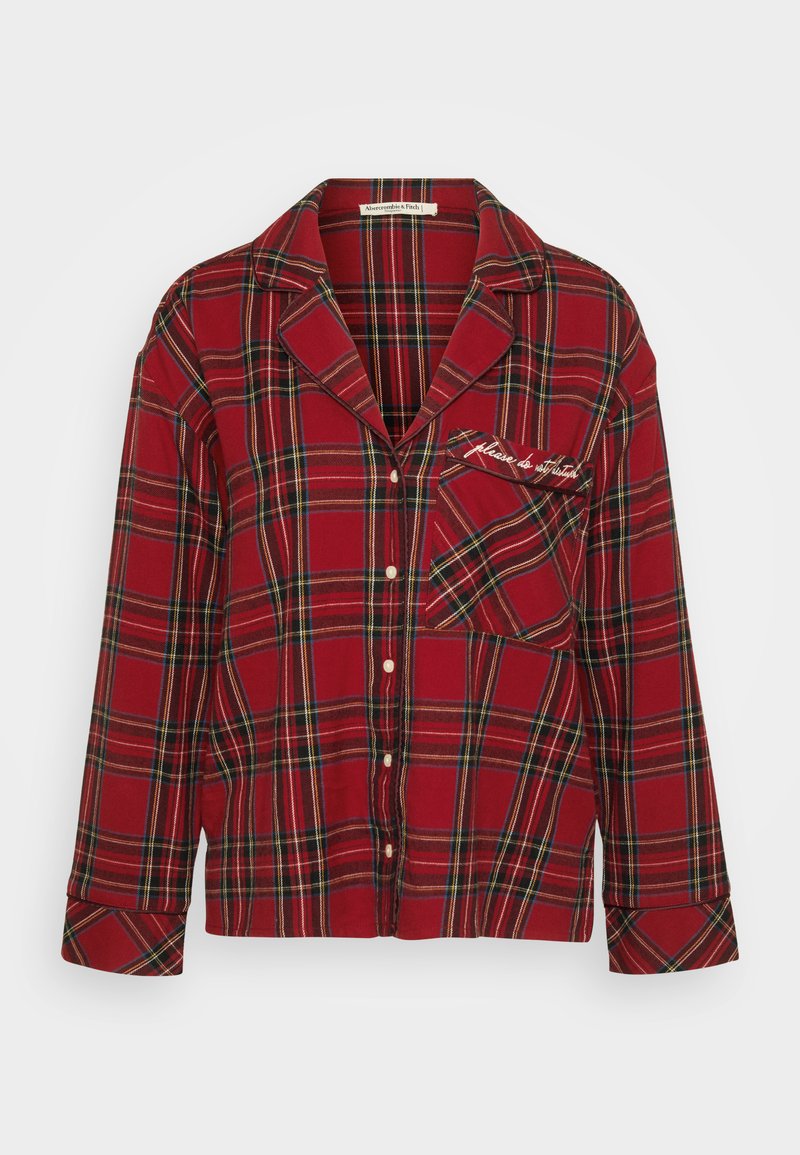 Rot kariertes Flanell-Pyjama-Oberteil mit langen Ärmeln, Knopfschluss und Brusttasche, die mit gesticktem Text versehen ist. Weicher Stoff und lässiges Design.