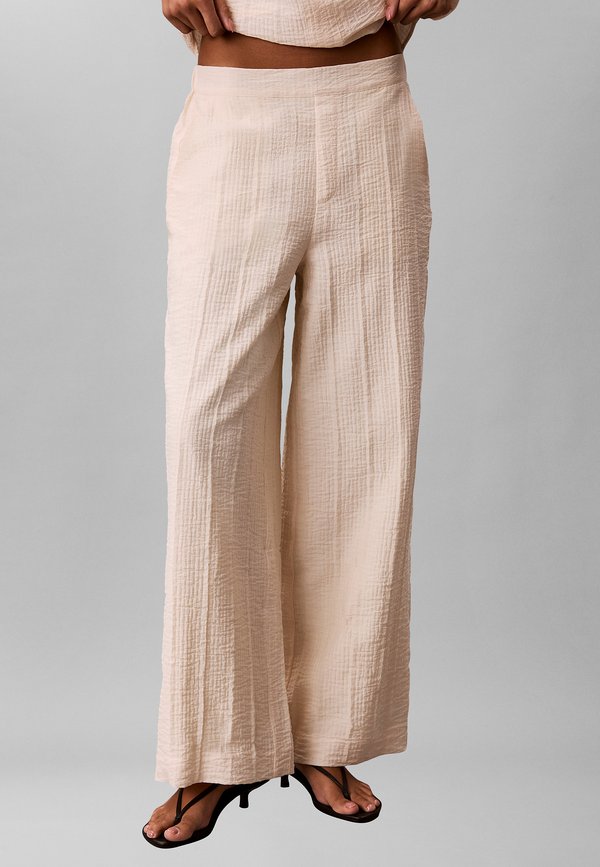 Calvin Klein CALVIN KLEIN RELAXED SHEER STRIPE CRINKLE TROUSERS - Trousers - beige
