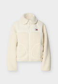 Sherpa-Jacke in Cremefarbe mit Stehkragen, Reißverschluss, großen Fronttaschen und einem kontrastierenden oberen Bereich aus glattem Stoff.