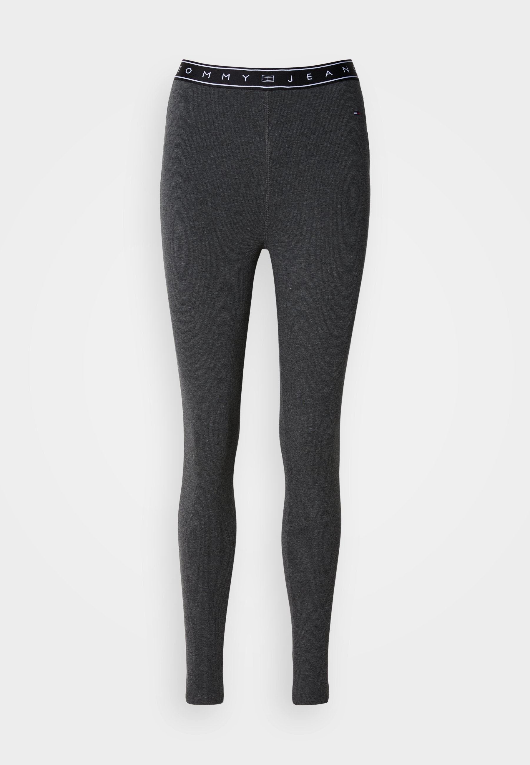Dunkelgraue Leggings mit figurbetontem Schnitt, aus Baumwollmischgewebe gefertigt. Verfügen über einen schwarzen Bund mit der Aufschrift "TOMMY JEAN" in weißer Schrift.
