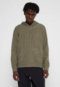 Olivgrüner Cord-Hoodie mit Känguru-Tasche und besticktem Detail, im lässigen Schnitt und mit strukturierter Oberfläche.