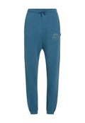 Hellblaue Jogginghose mit elastischem Bund und Kordelzug. Verziert mit einem dekorativen Sonnengrafik in Gold auf dem linken Oberschenkel. Mit Bündchen an den Knöcheln.