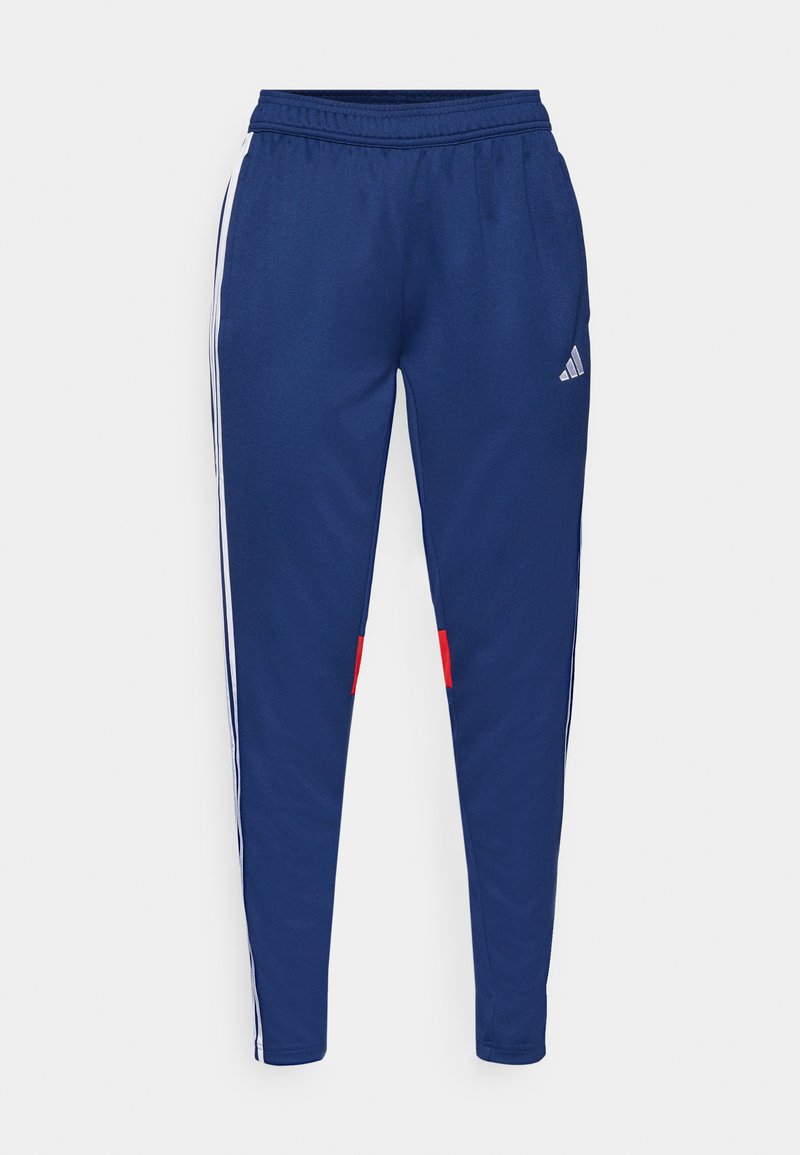 Marineblaue Jogginghosen mit weißen Seitenstreifen, elastischem Bund und roten Akzenten am Saum. Aus glattem, leichtem Stoff gefertigt.