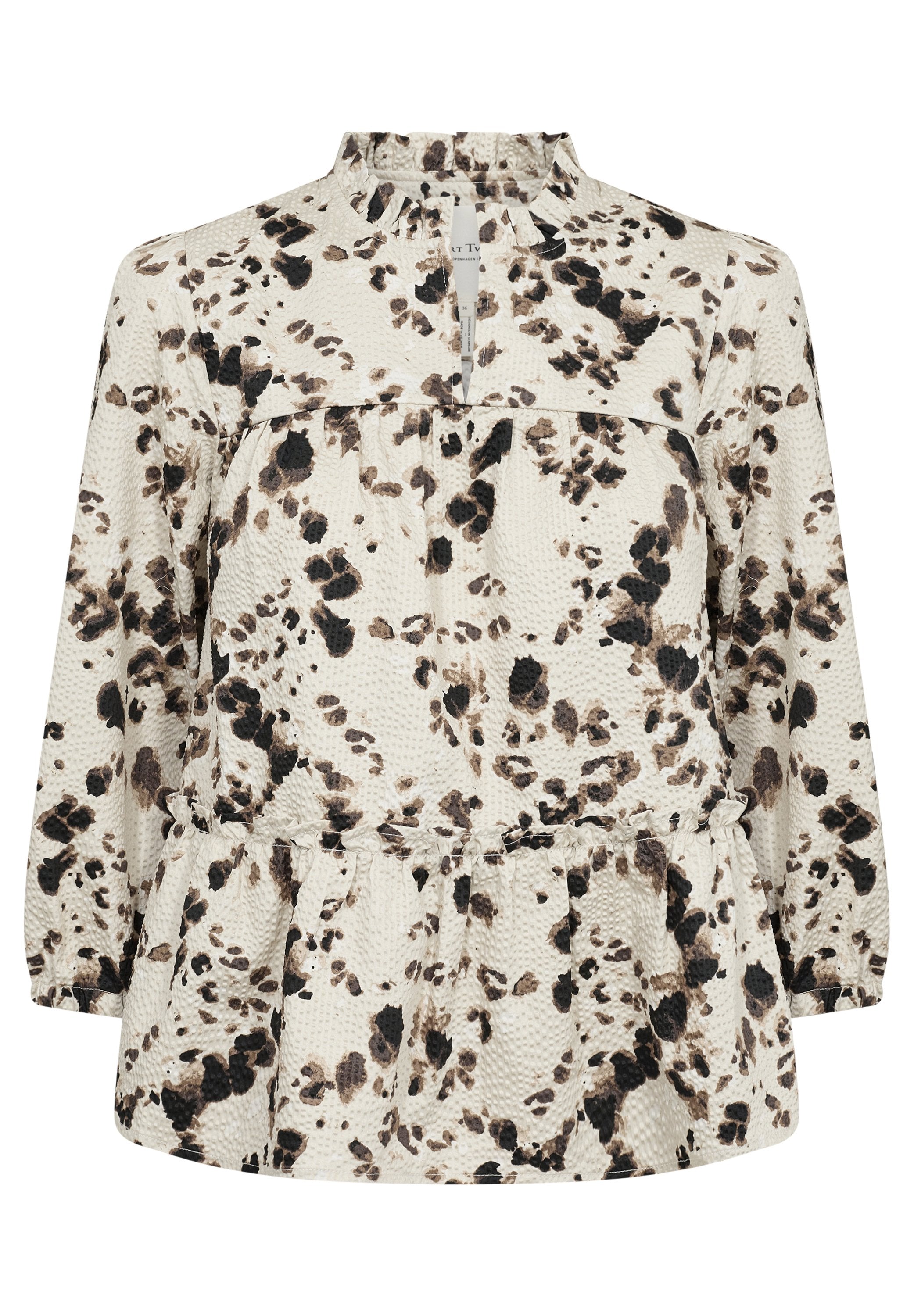 Langärmlige Bluse in Creme mit schwarzen und braunen abstrakten Punkten. Verfügt über einen Rüschensaum und einen gerafften Saum für eine lockere Passform.
