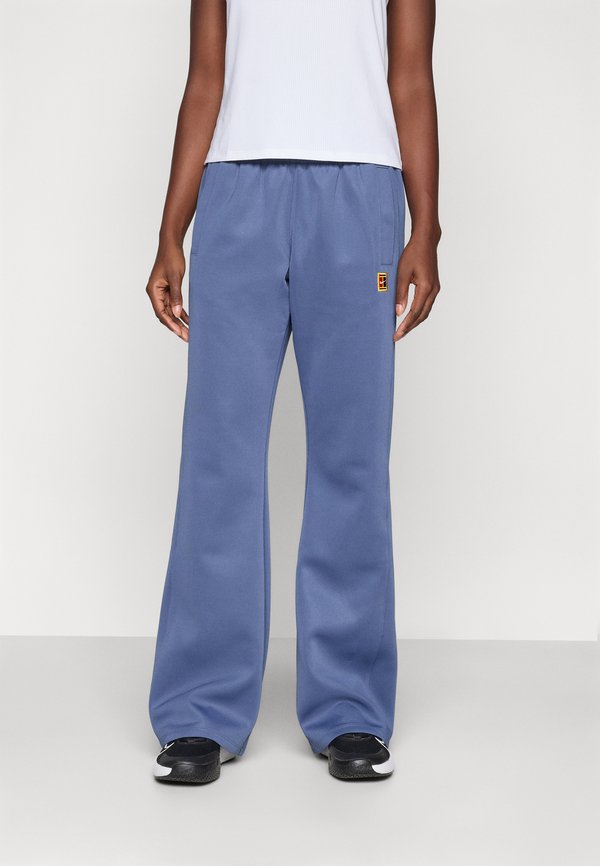 Nike Performance NIKECOURT PANT HERITAGE - Tracksuit bottoms - diffused blue