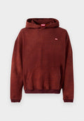 Rostbrauner Kapuzenpullover aus weichem Stoff, mit einer Fronttasche und gerippten Bündchen. Kleines "DIESEL"-Logo in kontrastierender Farbe auf der Brust.