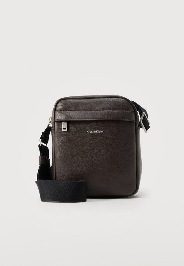 Calvin Klein RAISED REPORTER - Cross body bag - dark brown