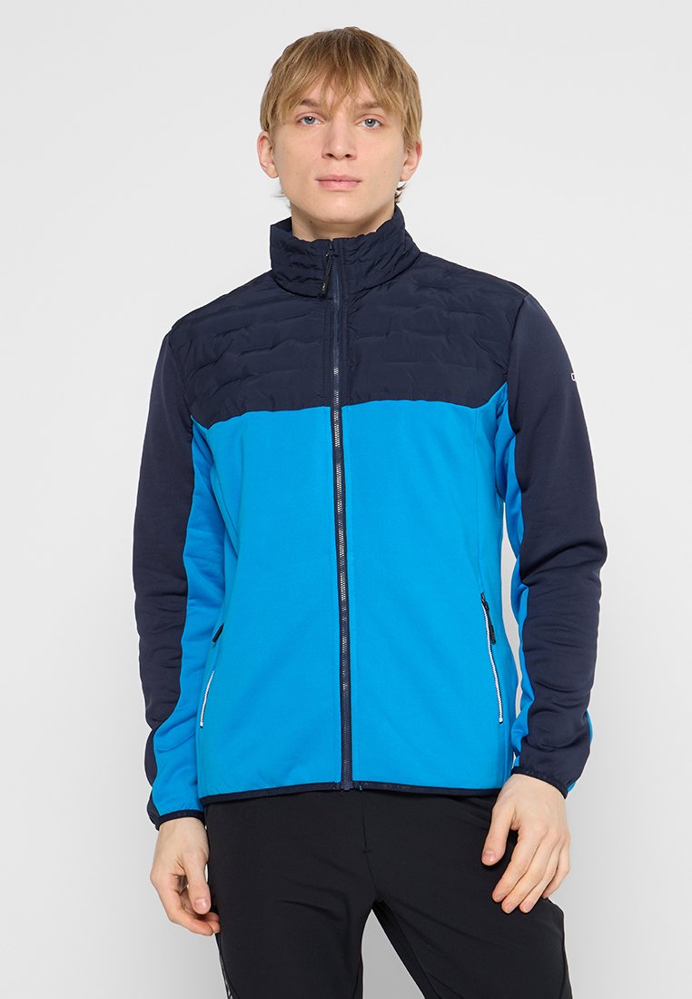 Herrenjacke mit einem Color-Block-Design, das einen blauen oberen Teil und einen leuchtend blauen unteren Abschnitt aufweist. Hergestellt aus leichtem, strukturiertem Stoff mit Reißverschlusstaschen.
