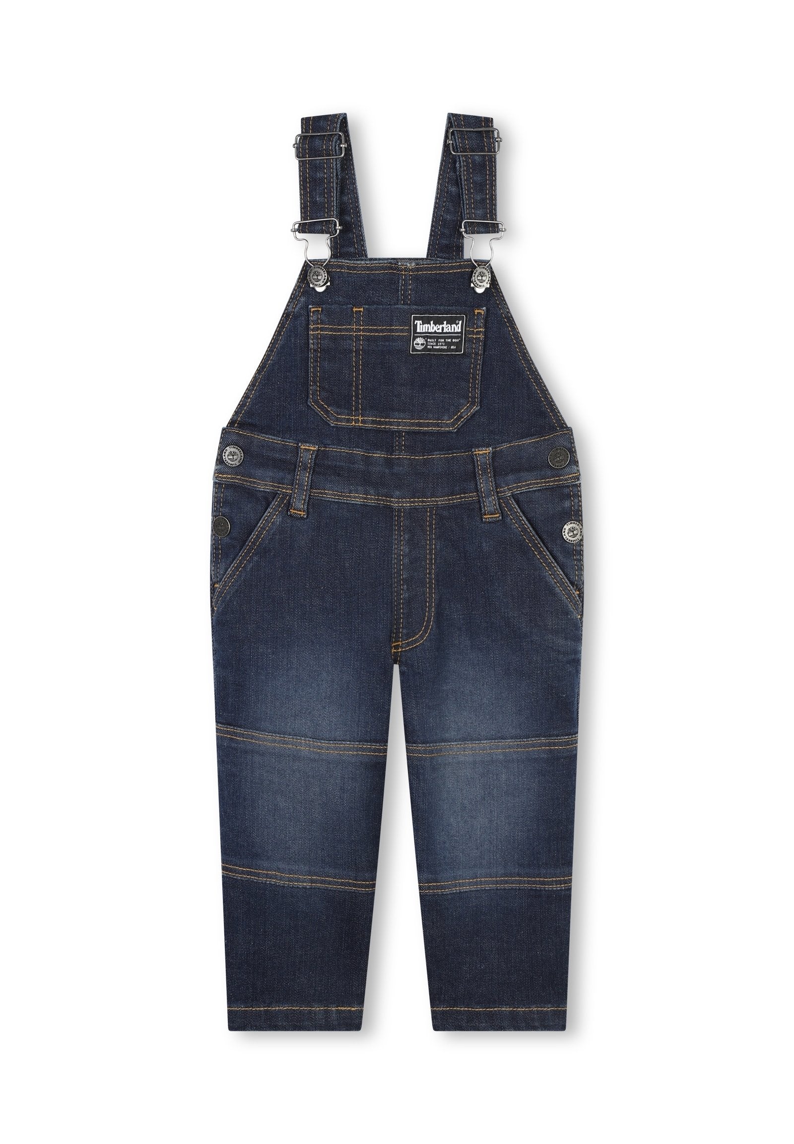 Dunkelblaue Jeanslatzhosen mit verstellbaren Trägern, Vordertasche und kontrastierenden gelben Nähten. Mit Knopfverschlüssen und schmal zulaufenden Beinen.