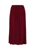 Roter Rock mit einem elastischen Bündchen und Kordelzug. Verfügt über ein strukturiertes Muster, das kleineren Rechtecken in dunklerem Rot ähnelt.