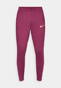 Bordeauxfarbene Sporthose mit schmalem Schnitt, elastischem Bund und kleinem beigen Nike-Logo am linken Oberschenkel. Glattes, dehnbares Material.