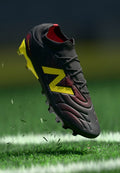 New Balance TEKELA V5 TEAM FG - Firm-ground football boots - black 100/punch yellow/fire cracker
