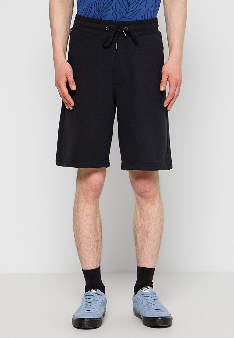 Schwarze Baumwollshorts mit elastischem Bund und Kordelzug. Glatte Textur, knielang, mit Seitentaschen und sauberen Nähdetails.