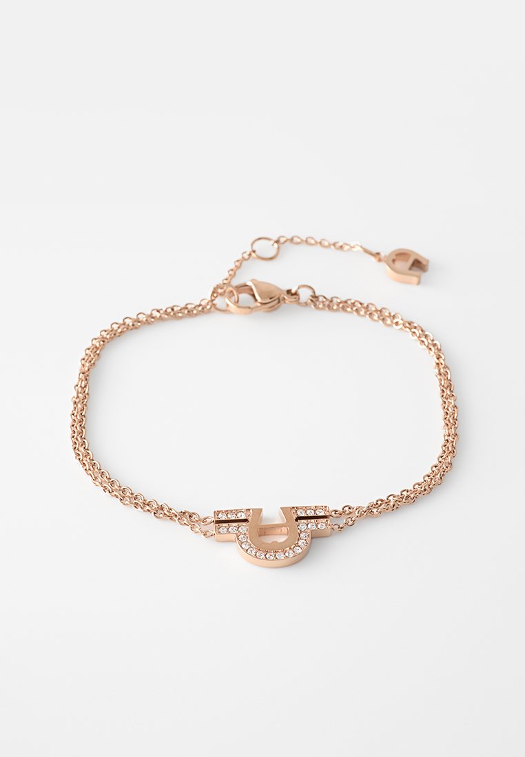 Armband aus Roségold mit einem U-förmigen Anhänger, der mit klaren Strasssteinen verziert ist, gesichert mit einem Karabinerverschluss und einer verstellbaren Kette.