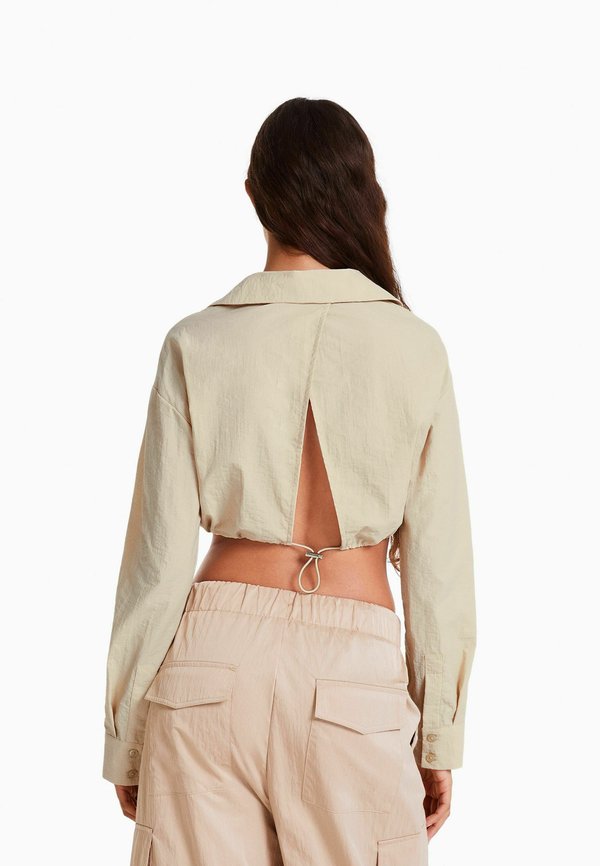 Bershka LONG SLEEVE AND GATHERED DETAIL AT THE FRONT WITH STOPPER