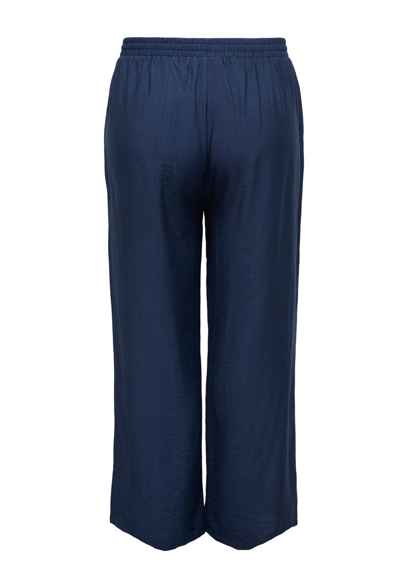 Marineblaue, weit geschnittene Hose mit elastischem Bund, strukturiertem Stoff und weiten Beinen, von hinten vor weißem Hintergrund gezeigt.