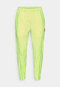 Neon-grüne Sporthose mit strukturierter Oberfläche, seitlichen Nähten in dunklerem Grün, einem elastischen Bund und geripptem Knöchelabschluss.