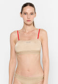 Beige Bralette mit roten Trägern, glatte Textur, mit "DIESEL"-Logo und gemusterter Band, die am unteren Rand "FÜR EINEN ERFOLGREICHEN LEBENSSTIL" liest.