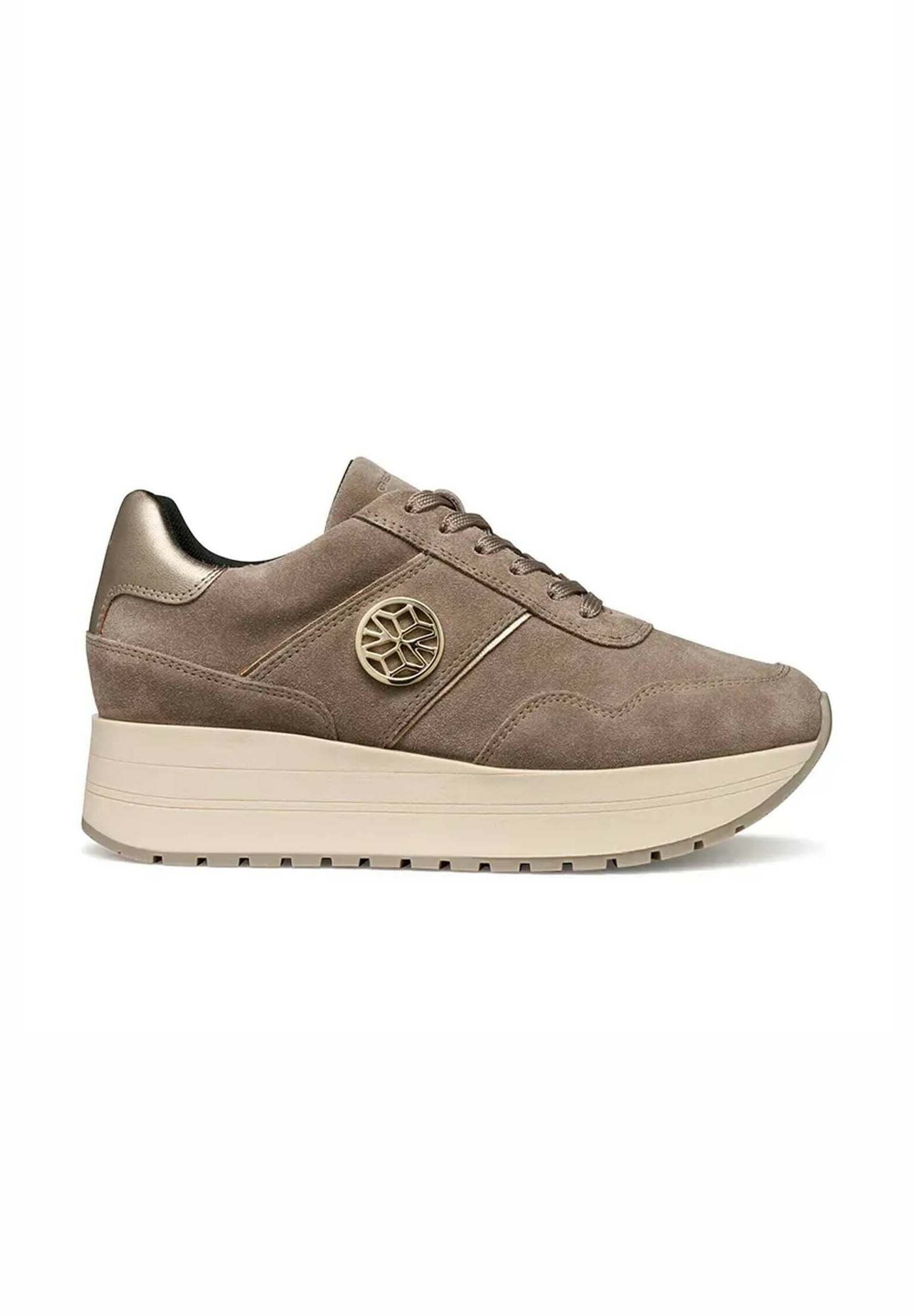 Wildledersneaker in Taupe mit strukturierter Oberfläche, ausgestattet mit einer beigen Plateausohle, Schnürverschluss vorne und einem metallischen Logoakzent an der Seite.