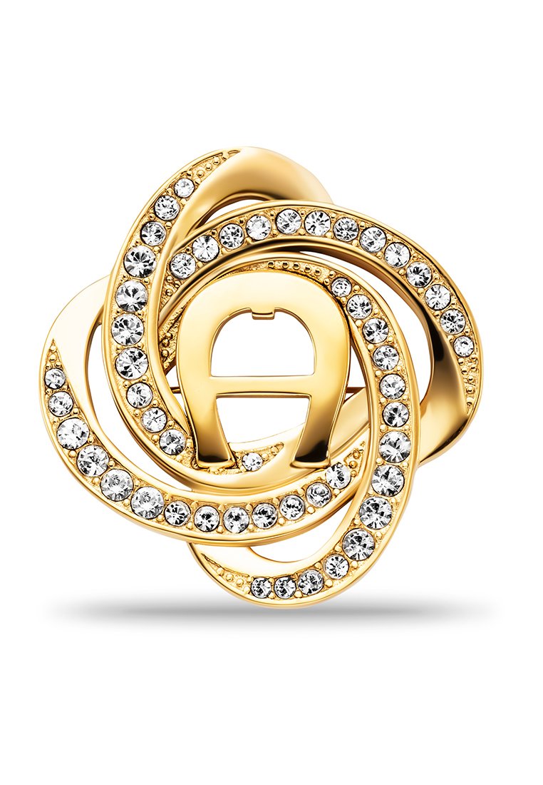 Goldene Brosche mit spiralförmigen Schlaufen, verziert mit funkelnden, klaren Kristallen auf einem weißen Hintergrund, der den Metallverschluss auf der Rückseite zeigt.