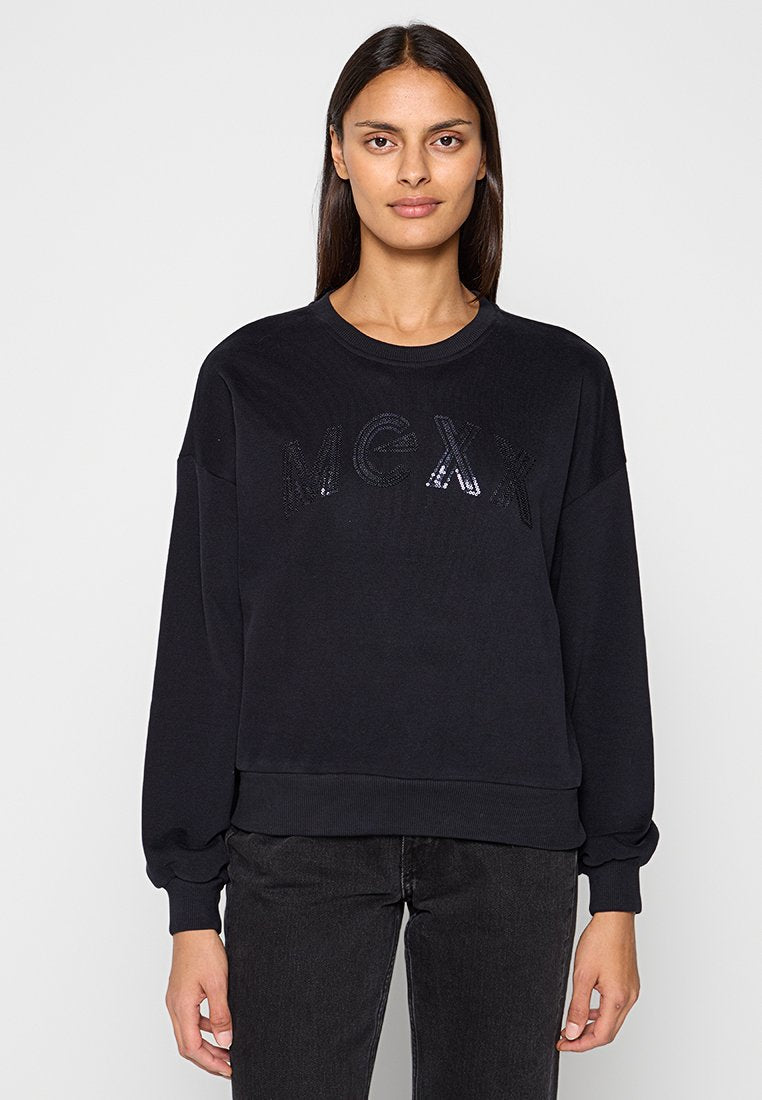 Schwarzer Pullover aus weichem Stoff mit "MEXX" in glänzenden Pailletten auf der Brust. Lange Ärmel mit gerippten Bündchen und Saum.
